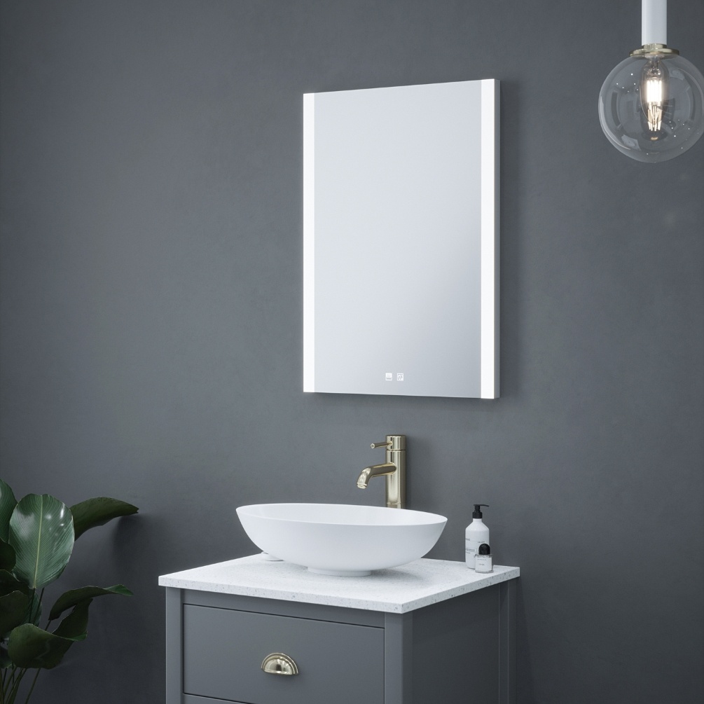 Product Lifestyle image of the Octagon Colour Changing LED Mirror mounted above a vanity unit with countertop basin